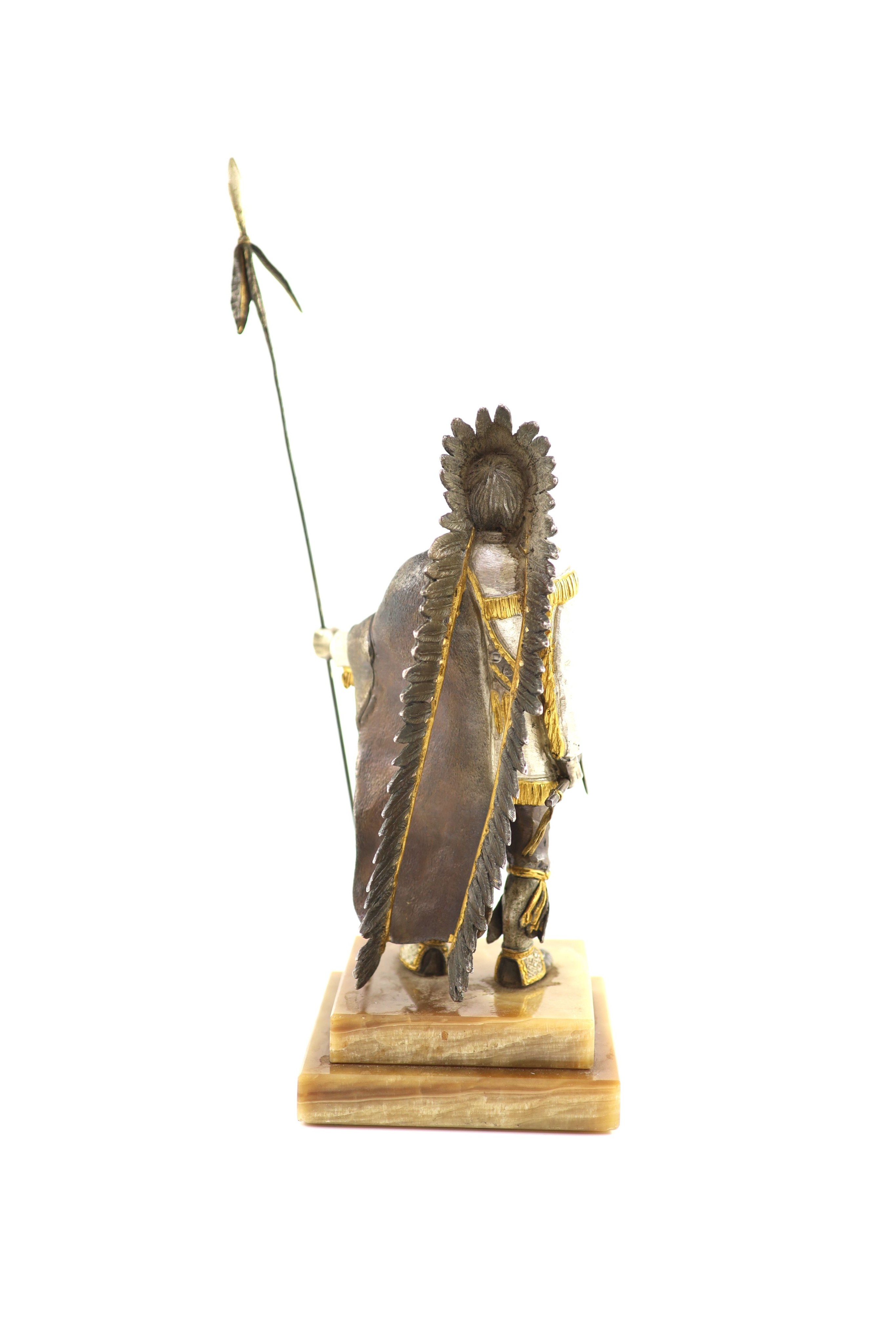 After Carl Kauba, a gilded, silvered and patinated bronze figure of a Native American chieftain, H 36 cm. (from tip of spear)